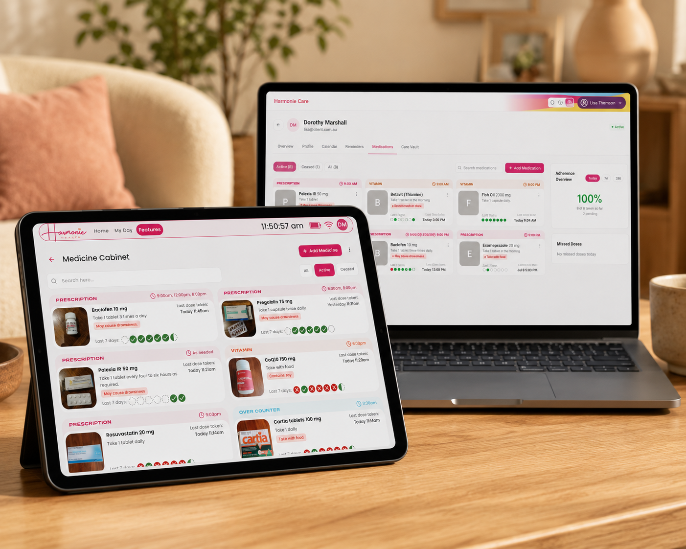A tablet and laptop on a wooden table in a cozy living room setting, both displaying a digital inventory or recipe management interface with pink and white UI elements.